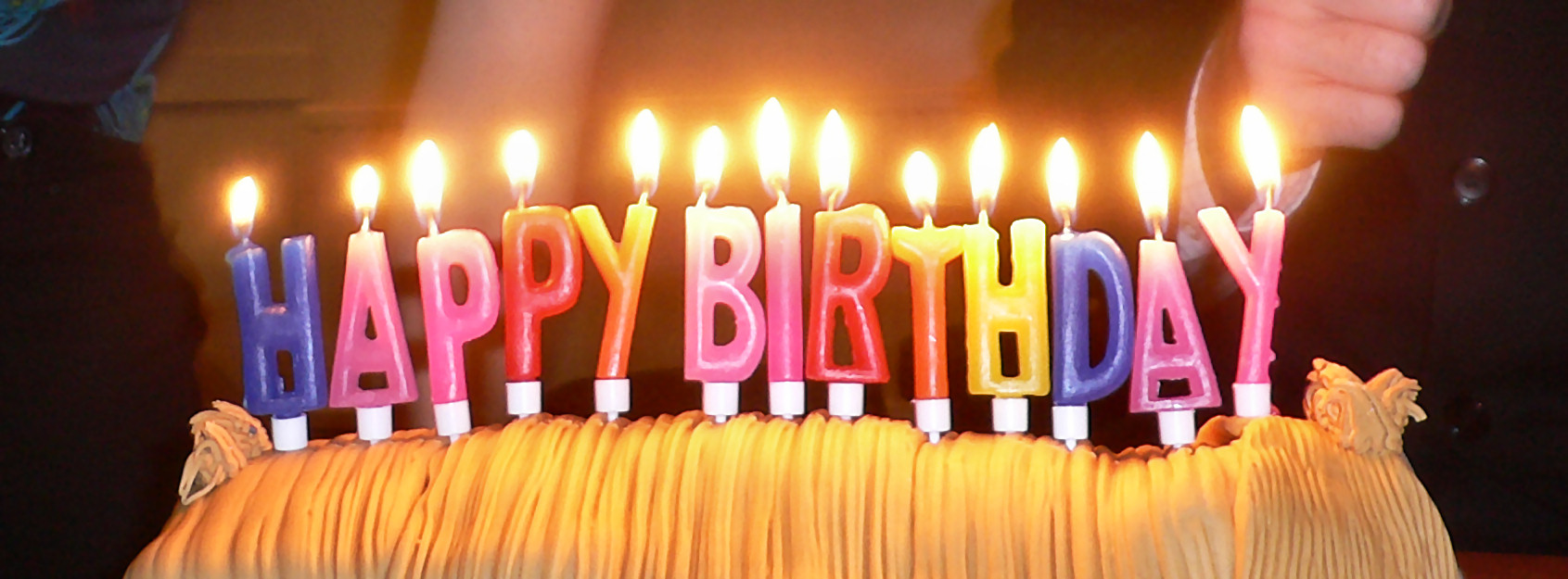 a cake with candles spelling 'Happy Birthday' on top of it